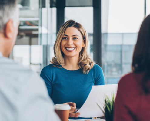 smiling woman having a meeting with another man and woman
